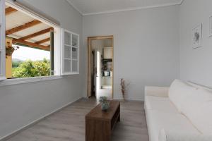 un soggiorno bianco con un divano e un tavolo di Cottage in the Nature by Konnect, Agios Markos Ipsos ad Ágios Márkos