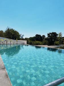 a large swimming pool with blue water at KADAGAN SUİTES AYASARANDA in Çeşme
