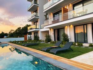 an image of a house with a swimming pool at KADAGAN SUİTES AYASARANDA in Çeşme