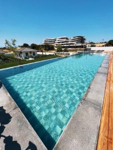 a large swimming pool with blue water at KADAGAN SUİTES AYASARANDA in Çeşme