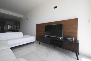 a living room with a white couch and a flat screen tv at Luxurious 3 bedroom apartment with breathtaking views - MMAI1-1 in St Julian's