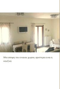 a living room with a television and a room with a bed at Central, fully equipped, 2 bedrooms, great view, wifi in Philotium