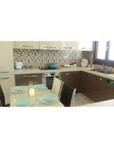 a kitchen with a table with plates and candles on it at Central, fully equipped, 2 bedrooms, great view, wifi in Philotium