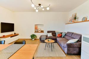 a living room with a couch and a table at Apartment Aura in Poreč