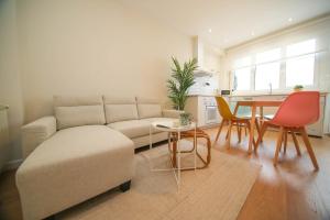 a living room with a couch and a table at Noreas Centro Lucus Augusti in Lugo