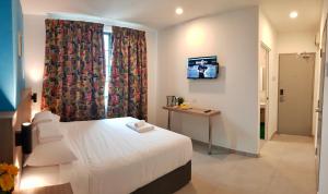 a hotel room with a bed and a television at HOTEL ORKID PORT KLANG in Klang