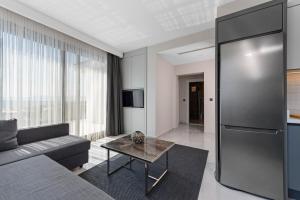 a living room with a couch and a table at KADAGAN SUİTES AYASARANDA in Çeşme
