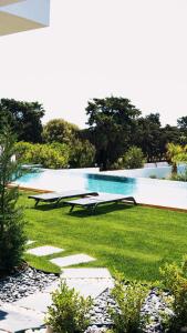 a swimming pool in the middle of a yard at KADAGAN SUİTES AYASARANDA in Çeşme