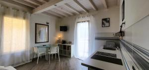 a kitchen with a table and a table and a window at Residence Ki House in Parma