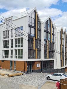 a building with a car parked in front of it at Baza Smart Hotel in Bukovel