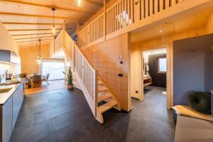 a wooden house with a staircase in a kitchen at Ratscheinerhof App Waldruhe in Lazfons