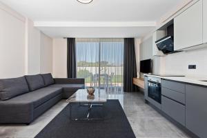 a living room with a couch and a table at KADAGAN SUİTES AYASARANDA in Çeşme