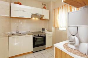 a kitchen with a sink and a stove top oven at Sunshine Apartment Doda in Vela Luka