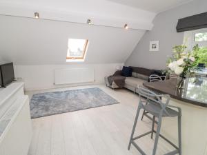 a living room with a table and a couch at 1 Old Kingdom Hall in Amlwch