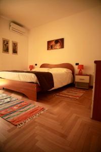a bedroom with a large bed and a wooden floor at La Torre in Tirano +20 photos