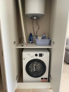 a laundry room with a washing machine in a closet at Sea Dreams Studio in Sveti Vlas +31 photos
