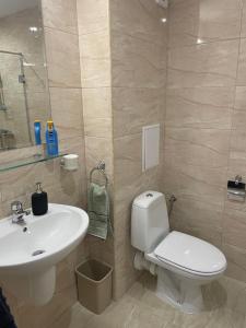 a bathroom with a white toilet and a sink at Sea Dreams Studio in Sveti Vlas