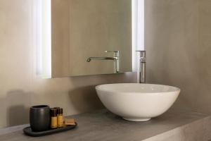 a white bowl sink on a counter in a bathroom at Hotel Villa Cedrino in Dorgali