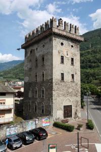 een groot stenen gebouw met een klok erop bij La Torre in Tirano