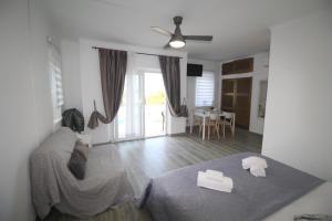 a bedroom with a bed and a living room at Casa do Milho in Carvoeiro
