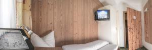 a room with a couch and a tv on a wall at Haus Tanja in Sölden