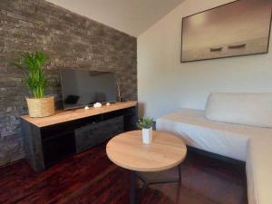 a small room with a bed and a table and a tv at Lifestyle apartment Podstrana in Podstrana