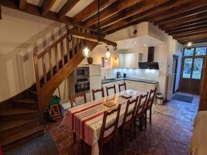 a kitchen and dining room with a table and chairs at Gîtes du Martroy in Nargis
