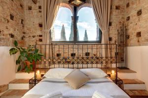 a bedroom with a bed with a large window at Terre di Baccio in Greve in Chianti