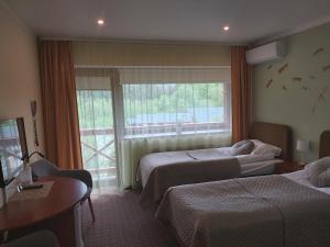 Postel nebo postele na pokoji v ubytování Hotel Green Smiltynė