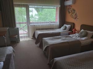 Postel nebo postele na pokoji v ubytování Hotel Green Smiltynė