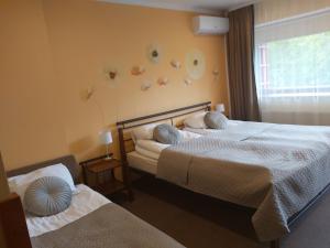 Postel nebo postele na pokoji v ubytování Hotel Green Smiltynė