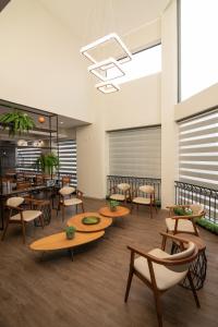 eine Lobby mit Tischen und Stühlen und eine Cafeteria in der Unterkunft EKO HOTEL in Presidente Prudente