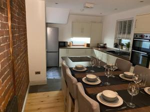 a kitchen with a table with chairs and a dining room at Dolwen Snowdonia Home by PolkaDot in Caernarfon