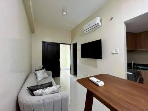 a living room with a couch and a table at 1BR Unit - MIGAs Haven @ One Pavilion Place in Cebu City