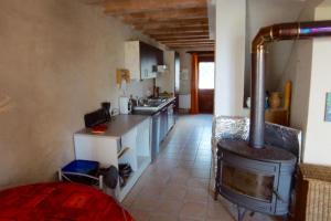 a kitchen with a stove in the middle of it at Gites PassionPastel in Pech-Luna