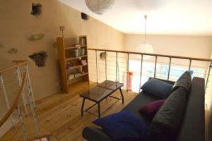 a living room with a couch and a table at Gites PassionPastel in Pech-Luna