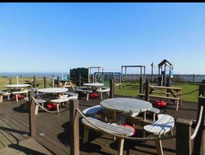 an empty playground with tables and a play structure at Fernly Holiday Home in Corton