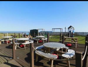 an empty playground with tables and a play structure at 18, Waterside park, Fernly Holiday Home in Corton