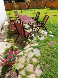 una mesa de picnic y sillas en un patio con flores en Chalupa U přátel en Kovářská