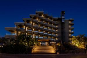 a hotel at night with stairs leading up to it at Hotel Faro, a Lopesan Collection Hotel - Adults Only in Maspalomas