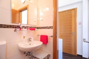 a bathroom with a sink and a mirror at Villa Fio - Rooms & Studio in Hvar