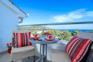 a table on a balcony with a bowl of fruit on it at Villa Fio - Rooms & Studio in Hvar