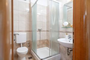 a bathroom with a shower and a toilet and a sink at Villa Fio - Rooms & Studio in Hvar