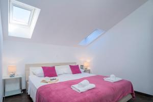 a bedroom with a bed with two towels on it at Villa Fio - Rooms & Studio in Hvar
