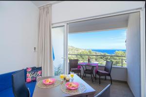 a dining room with a table and a balcony at Rooms & Studio Villa Fio in Hvar