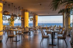 a restaurant with a view of the ocean at Hotel Faro, a Lopesan Collection Hotel - Adults Only in Maspalomas
