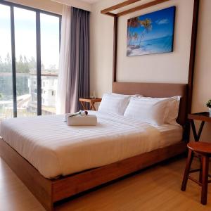 a bedroom with a large bed with a large window at DS Timurbay Residence in Kuantan