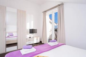 a bedroom with two beds and a large mirror at Villa Fio in Hvar