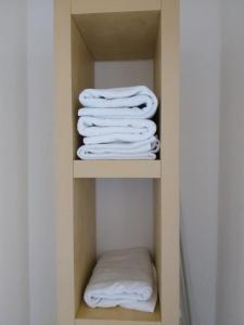 grupa białych ręczników w szafie w obiekcie JIYARA F3 PROCHE CENTRE Ville w Belfort