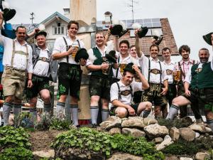 a group of men posing for a picture in a garden at Gasthof zum Hirsch in Görisried